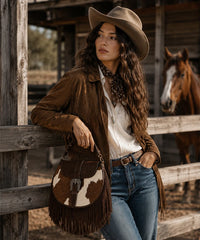 Trinity Ranch Cowhide Saddle Bag — genuine leather with cowhide print and fringe